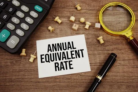 Annual Equivalent Rate text written on notepad with pen, alarm clock, magni.. Stock Photos