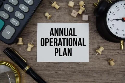 Annual Operational Plan text written on notepad with pen, alarm clock, magn.. Stock Photos