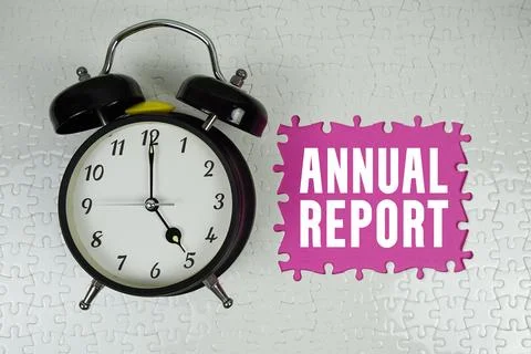 Annual Report text with alarm clock on pink background Stock Photos