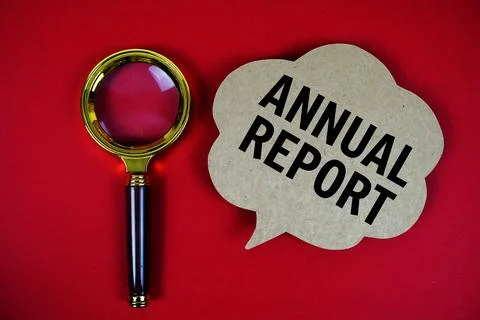 Annual Report text with speech bubble and magnifying glass on red background Stock Photos