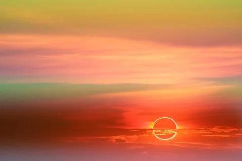 Annular eclipse over colorful soft cloud sunset sky Stock Photos
