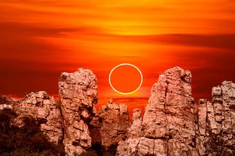 Annular eclipse over stone on the rock of cliff Stock Photos