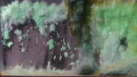 Anode sludge collects on a nickel plate during electrolysis, seen in time-lapse. Stock Footage 320458528