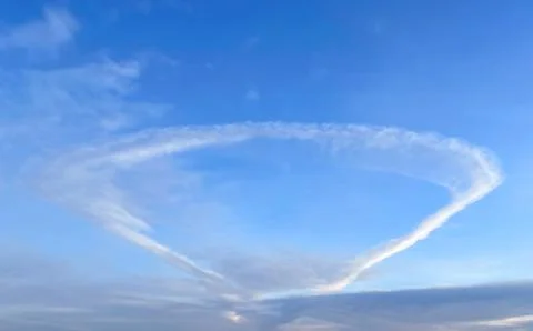 Anomalous cloud in the form of a ring in the blue sky Stock Photos