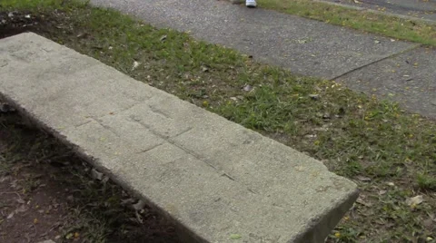 Anonimous guy sit on a public stone bench Stock Footage 46054634