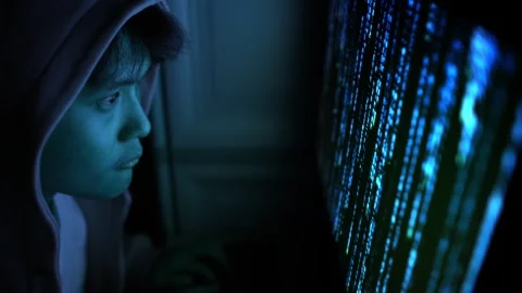 Anonymous Asian Hacker in Dark Room Facing Digital Code Screen, Cyber Security Stock Footage 336441847