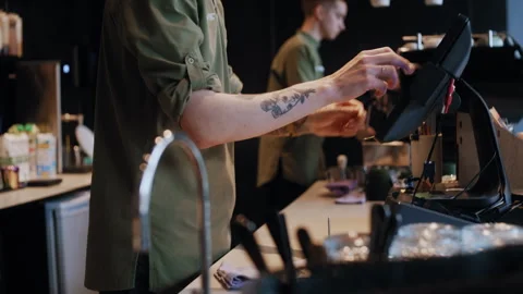 Anonymous barista using computer to serve client in modern cafeteria Stock-Footage 307572815