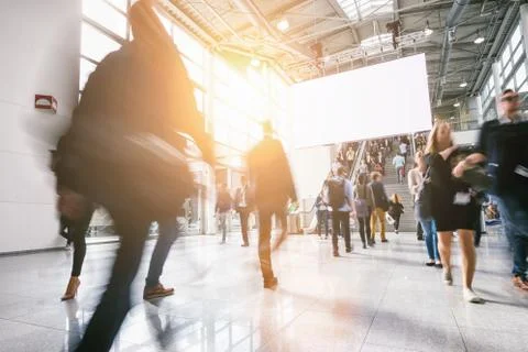 Anonymous blurred people at a trade show, including copy space banner Stock Photos