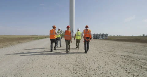 Anonymous colleagues walking towards windmill Stock Footage 140291281