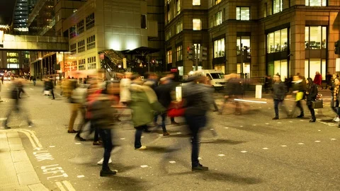 Anonymous commuters crossing a road at night at rush hour Video stock 101561327