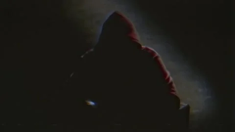 Anonymous computer hacker in a hood interview vintage VHS tape style video .. Stock Footage 302563688