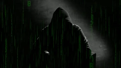 Anonymous computer hacker in a hood interview vintage VHS tape style video .. Stock Footage 302563689