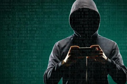 Anonymous computer hacker with a smartphone over abstract digital background Stock-Fotos