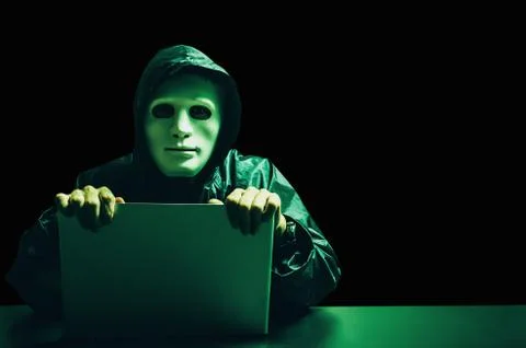 Anonymous computer hacker in white mask and hoodie,Data thief,internet attack Stock Photos