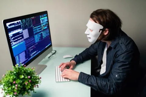 Anonymous computer hacker in white mask. Obscured dark face making silence ge 写真素材