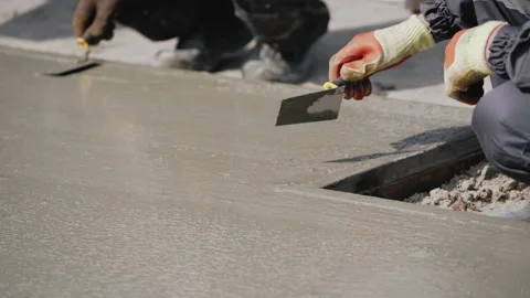 Anonymous Concrete Worker Smoothing Wet Sidewalk. Pouring Concrete. A factory Stock Footage 152021448