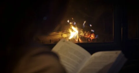 Anonymous Cozy, girl sitting by the fire... | Stock Video | Pond5