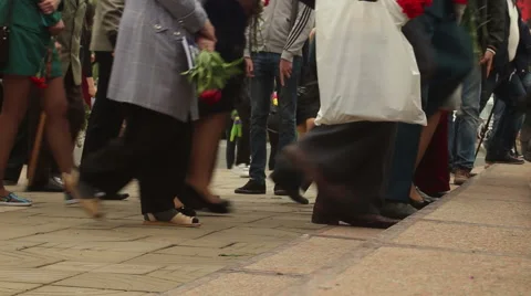 Anonymous crowd climbing stairs from left to right with flowers Stock Footage 63504785