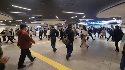 Anonymous crowd of commuters walking in the busy underground passage Stock Footage 337181377
