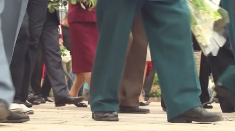 Anonymous crowd goes from left to right with flowers 스톡 동영상 63504820