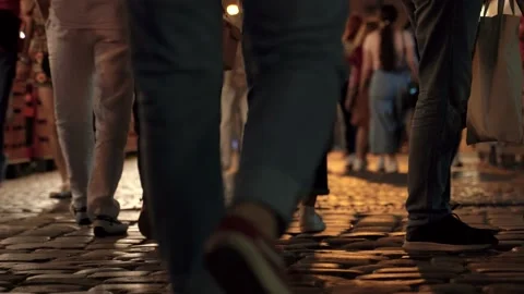 Anonymous crowd legs walking on cobblestone Stock Footage 189968078