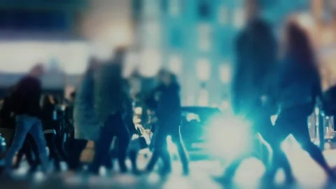 Anonymous crowd of pedestrians cross a busy city intersection on a winter night Stock Footage