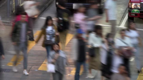 Anonymous crowd of pedestrians crossing a busy street on a crosswalk Stock Footage 345147130