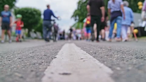 Anonymous Crowd of People Walking On Closed Street Boulevard at Community Picnic Stock Footage 277479193