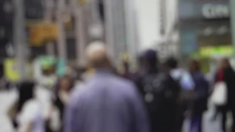 Anonymous crowd of people walking down a busy, blurry city street in an urban Stock Footage 342409638