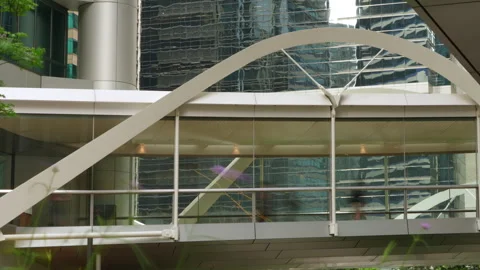 Anonymous crowd of people walking inside a modern pedestrian bridge Video stock 335380369