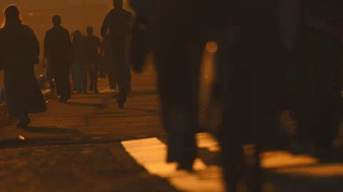 Anonymous crowd of people walking at sunset Stock Footage 330201424