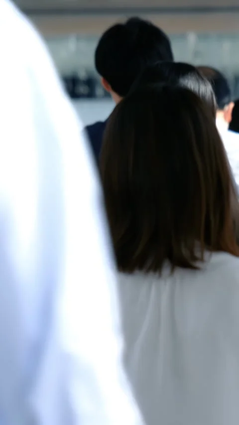 Anonymous crowd of travelers moving through a modern urban walkway Stock Footage 282070145