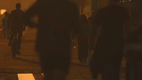 Anonymous crowd walking on the street at sunset Stock Footage 330198827