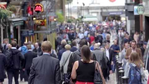 Anonymous crowd walks down street at rush hour Stock Footage 70550768