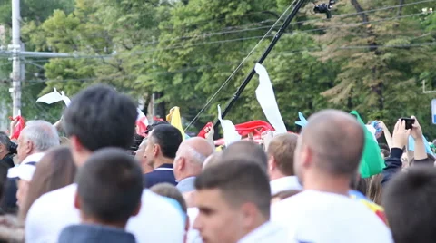 Anonymous crowd waving colored flags at the concert Stock Footage 63503142