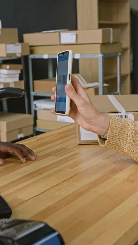 Anonymous Customer with Smartphone Picking Up Parcel at Delivery Office Stock Footage 321463838