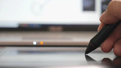 Anonymous designer working on laptop computer and pentablet graphic tablet Stock Footage 149951879