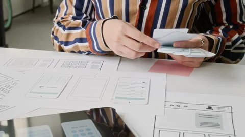 Anonymous Female Mobile App Developer Working with Wireframe Prototypes Stock Footage 327906716