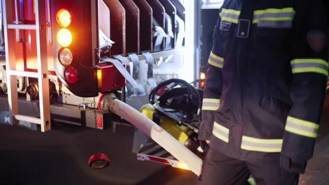 Anonymous Firefighter Passing by a Firetruck in Action During Emergency Video stock 302197842