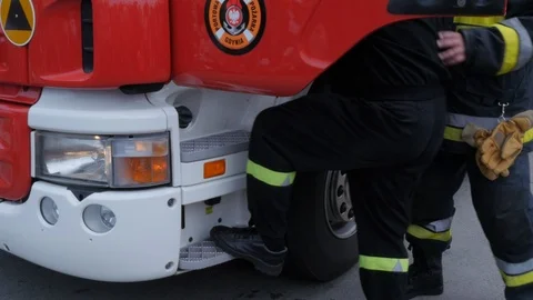Anonymous fireman leaving fire engine Stock Footage 92420966