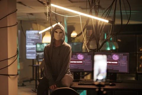 Anonymous hacker attacking database server portrait, cybercrime Fotos de archivo