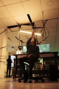 Anonymous hacker coding malware in ar, making hand gesture Stock-Fotos