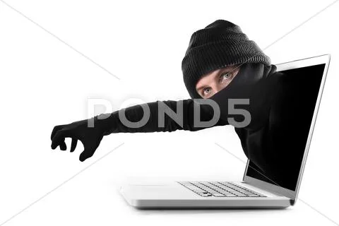 Anonymous hacker cyber criminal man coming out from computer laptop screen Stock Photos