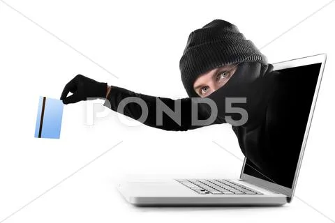 Anonymous hacker cyber criminal man coming out from computer laptop screen Stock Photos
