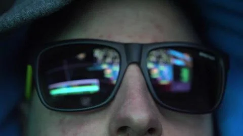 Anonymous Hacker in Dark Glasses Looking at Computer Screen Code Reflections Stockfoto's
