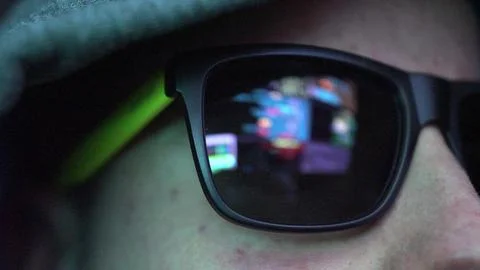 Anonymous Hacker in Dark Glasses Looking at Computer Screen Code Reflections Foto stock