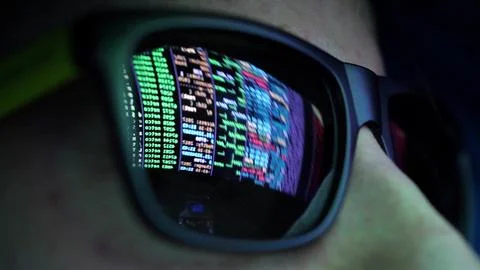 Anonymous Hacker in Dark Glasses Looking at Computer Screen Code Reflections Foto stock