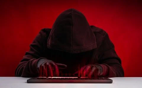 Anonymous hacker in dark hoodie using keyboard computer with digital code o.. Stock Photos