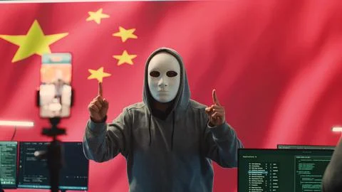 Anonymous hacker expert in a Chinese hacking high tech office Stock Photos