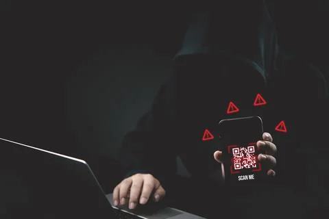 Anonymous hacker holding smartphone with malicious QR code scam and warning.. Stock Photos